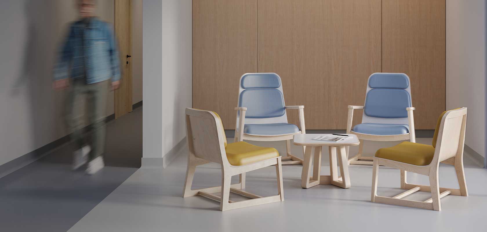 Espace d’attente avec Rock Lounge en bois clair, assises bleues et jaunes, et table basse centrale dans un environnement médical moderne